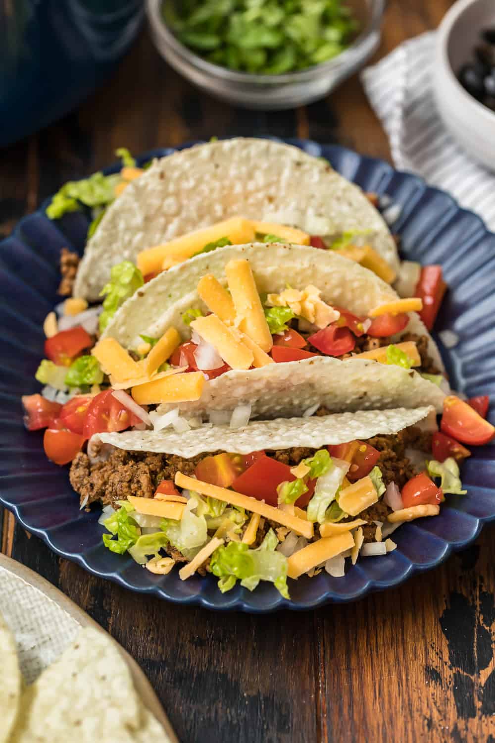 crockpot beef tacos on a blue plate.