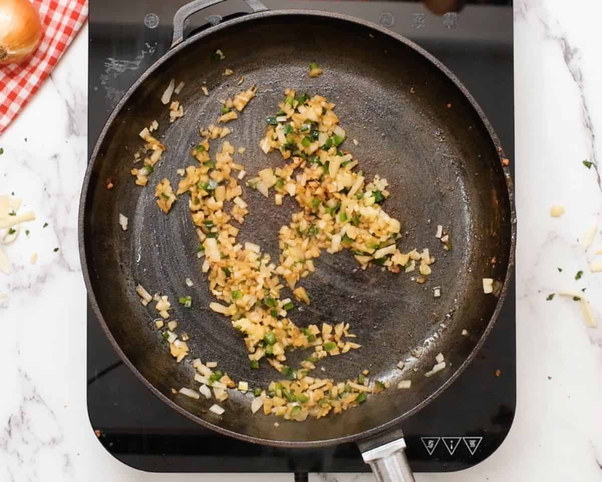 Diced onion, jalapeño, and garlic sautéing in the same skillet until softened and fragrant.