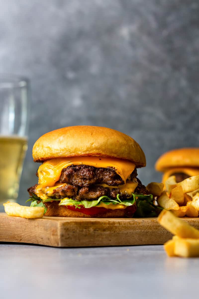 smash burgers on cutting board