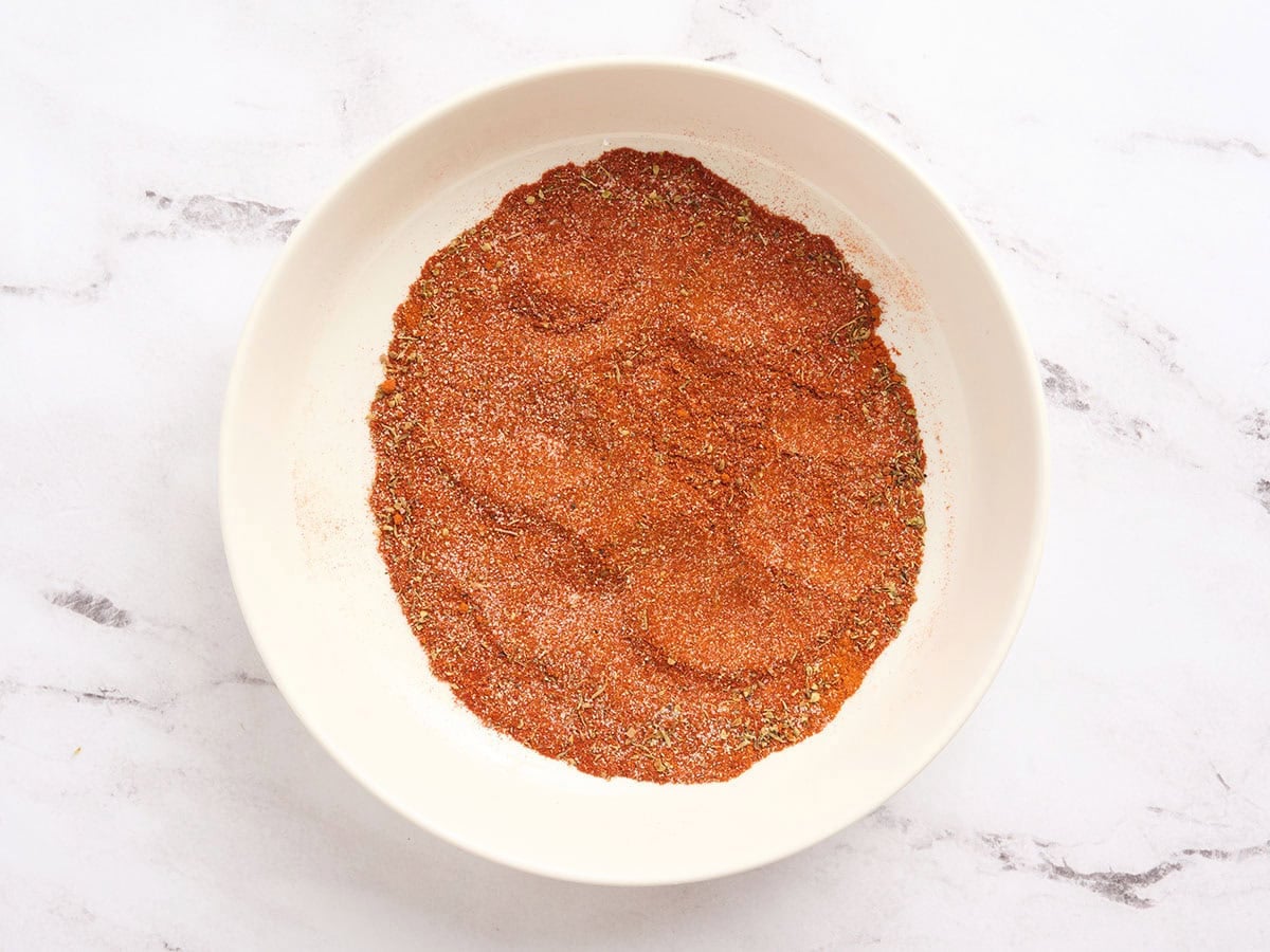Fully mixed blackened seasoning blend in a bowl with a uniform reddish spice mixture