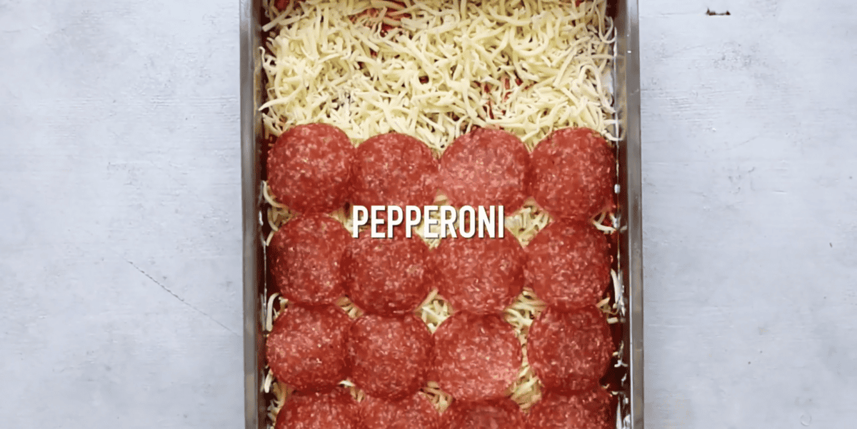 pepperoni slices over the cheese and sauce mixture