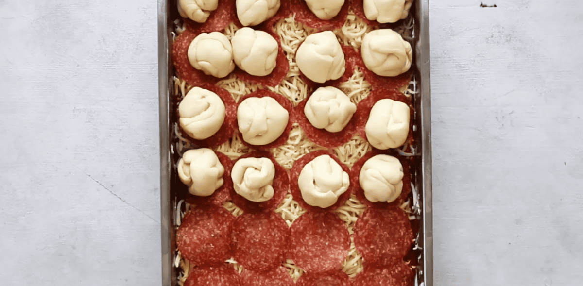 dough balls on top of the pepperoni