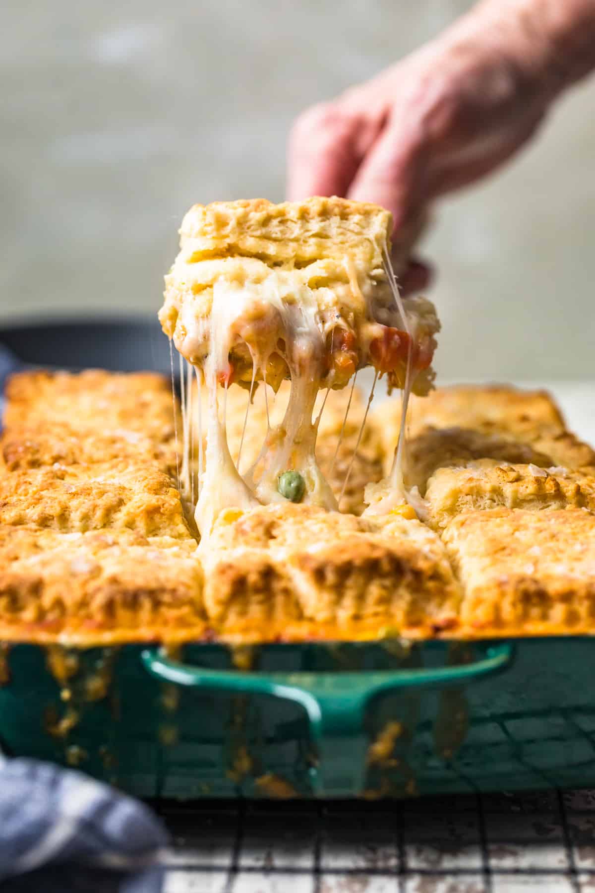 chicken pot pie being pulled out of baking dish