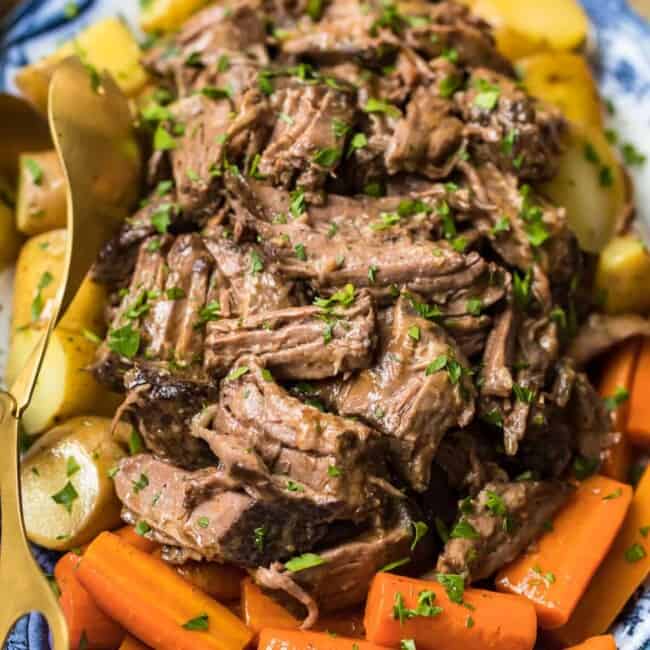 slow cooker pot roast on plate with carrots and potatoes