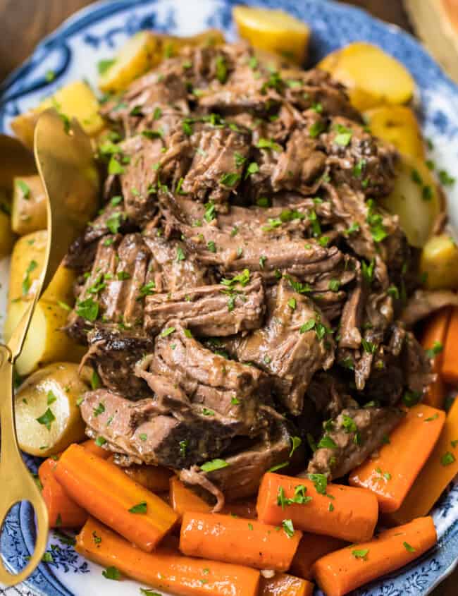 slow cooker pot roast on plate with carrots and potatoes