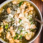 white bean parmesan soup with kale in a bowl