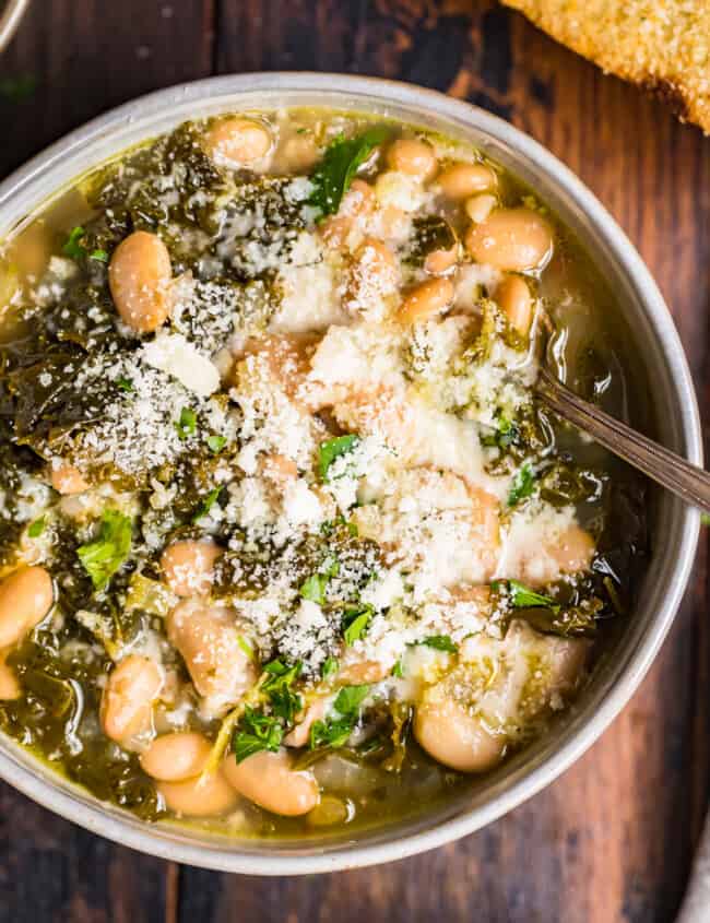 white bean parmesan soup with kale in a bowl
