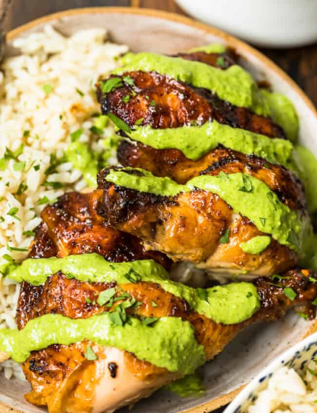 peruvian chicken with green sauce on plate