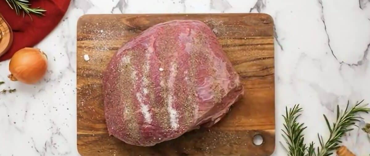 Seasoning the pot roast. 