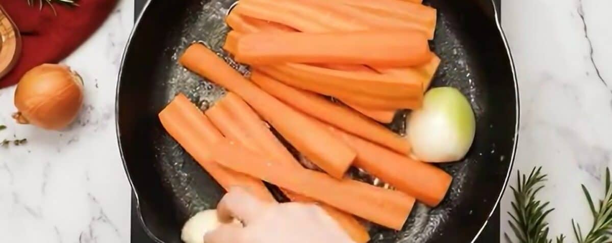 Searing the vegetables in a skillet. 