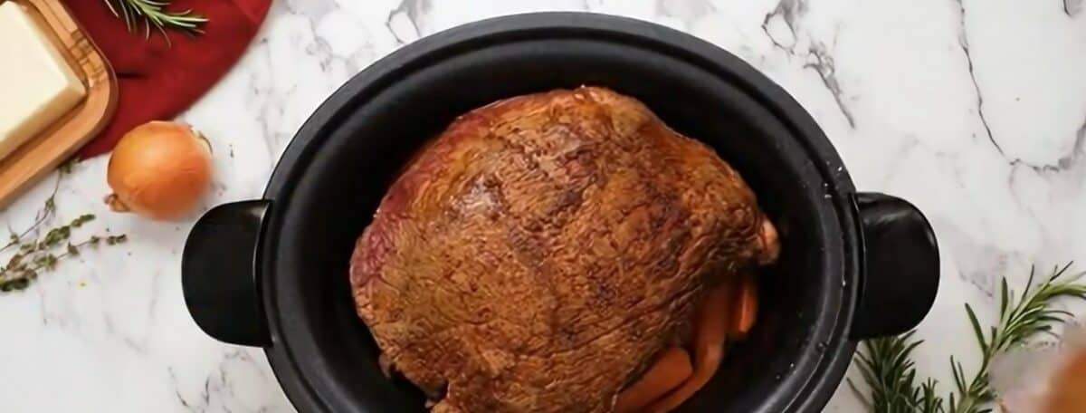 Veggies, roast, and seasonings in the crock pot. 