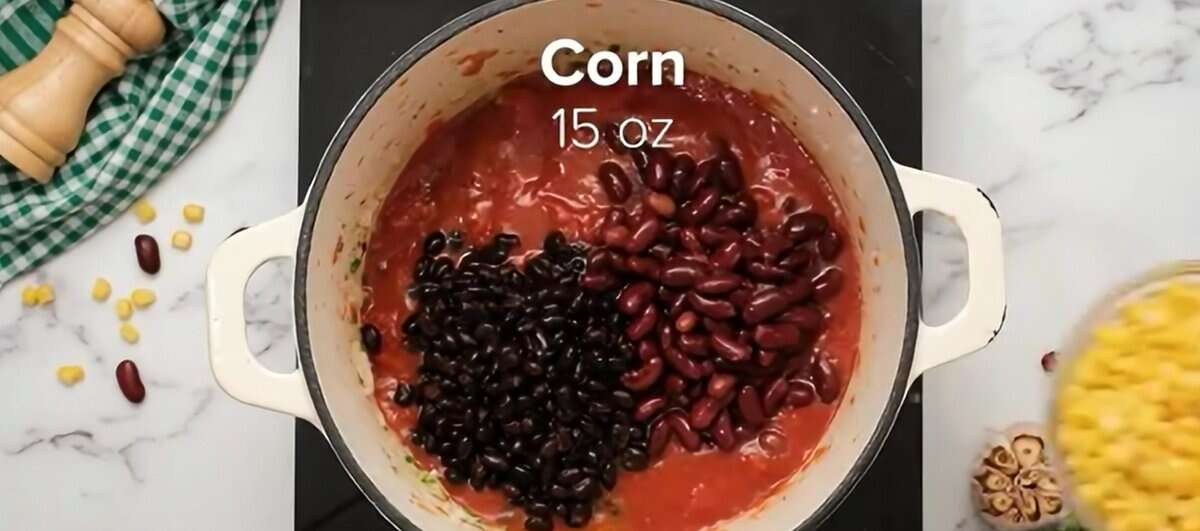 Adding beans and corn to the pot.