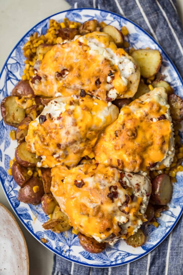 Bacon Crusted Chicken and potatoes on a blue and white plate