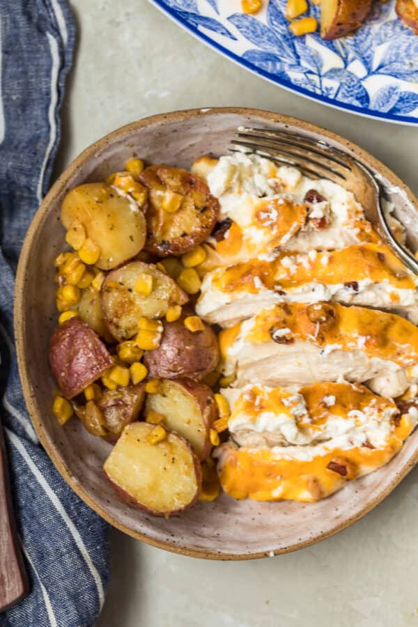Bacon Crusted Chicken sliced with the potatoes in a bowl