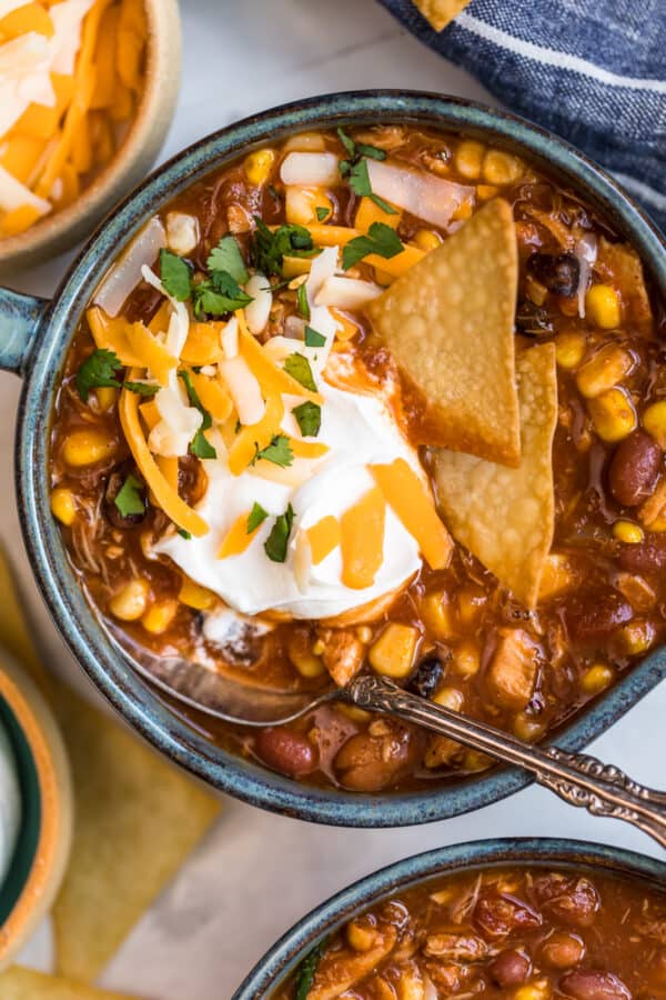 chicken taco soup in a bowl with chips and sour cream garnish