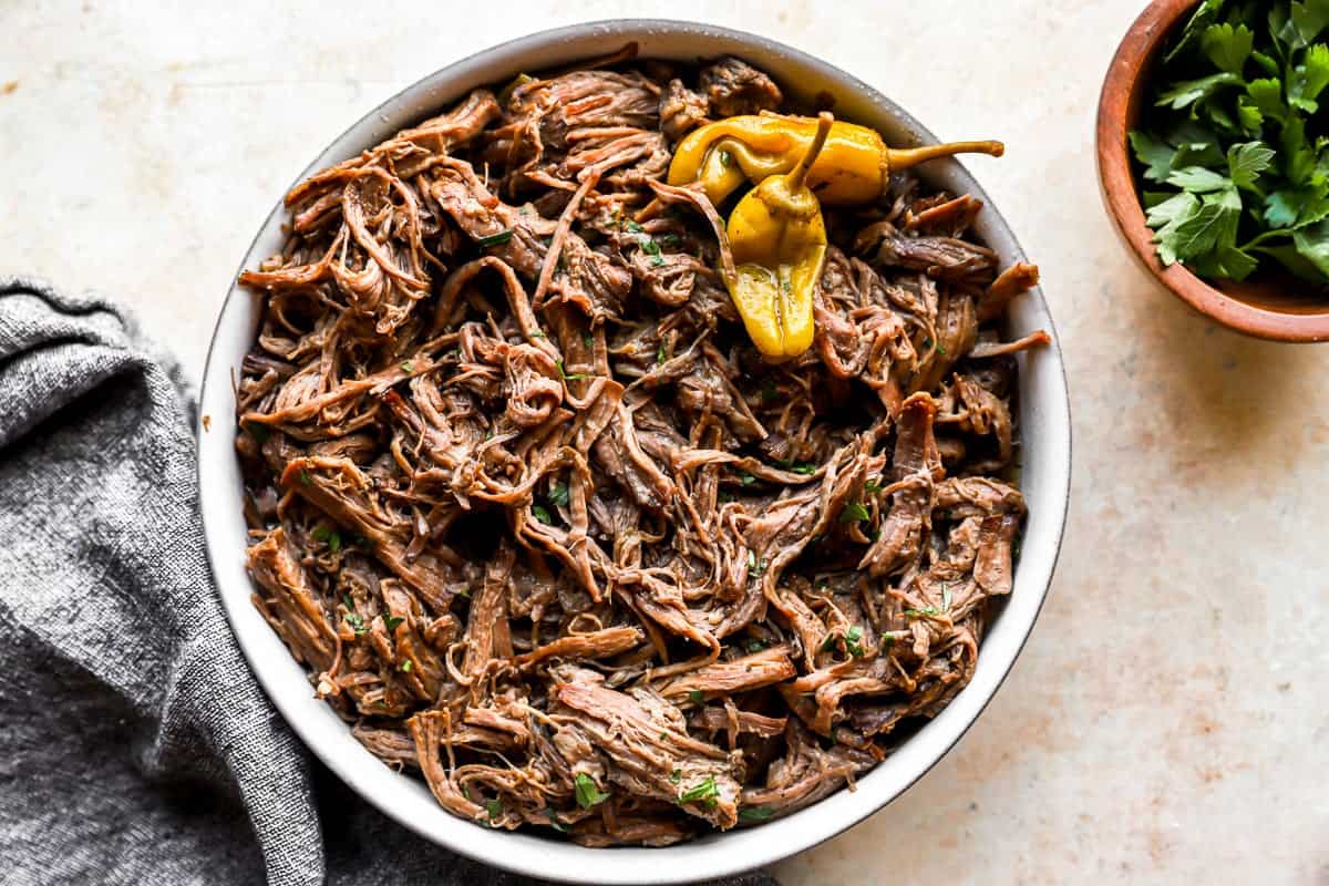 Mississippi pot roast-inspired Mexican pulled pork in a white bowl.