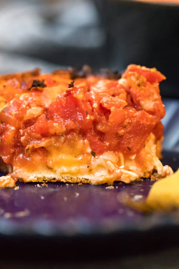 Close up of a slice of chicago deep dish pizza