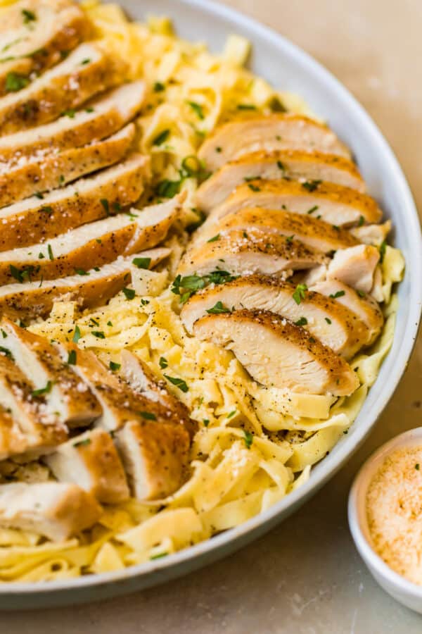 Chicken alfredo in a large white bowl