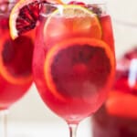non alcoholic sangria in a wine glass with citrus garnishes