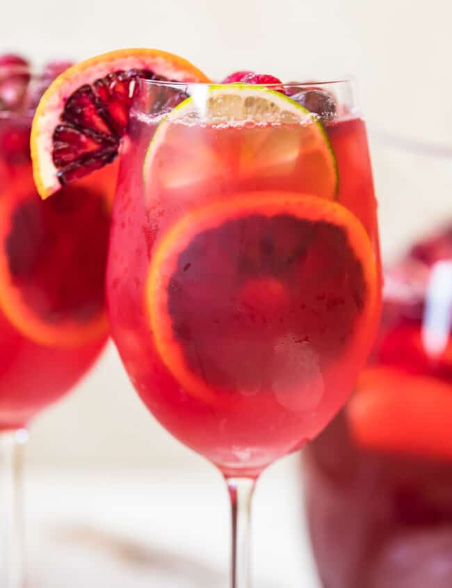 non alcoholic sangria in a wine glass with citrus garnishes