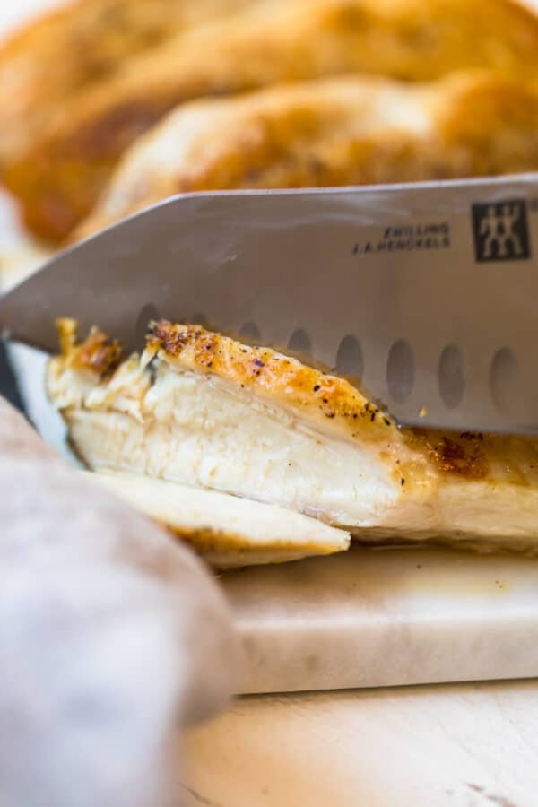 Slicing a Pan seared chicken breast with a sharp knife