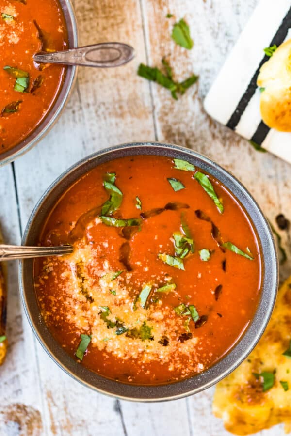Tomato soup served in a bowl with a spoon