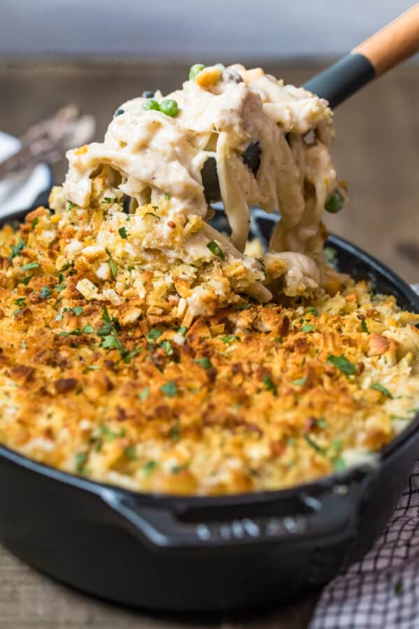 Noodles being lifted out of the baking dish