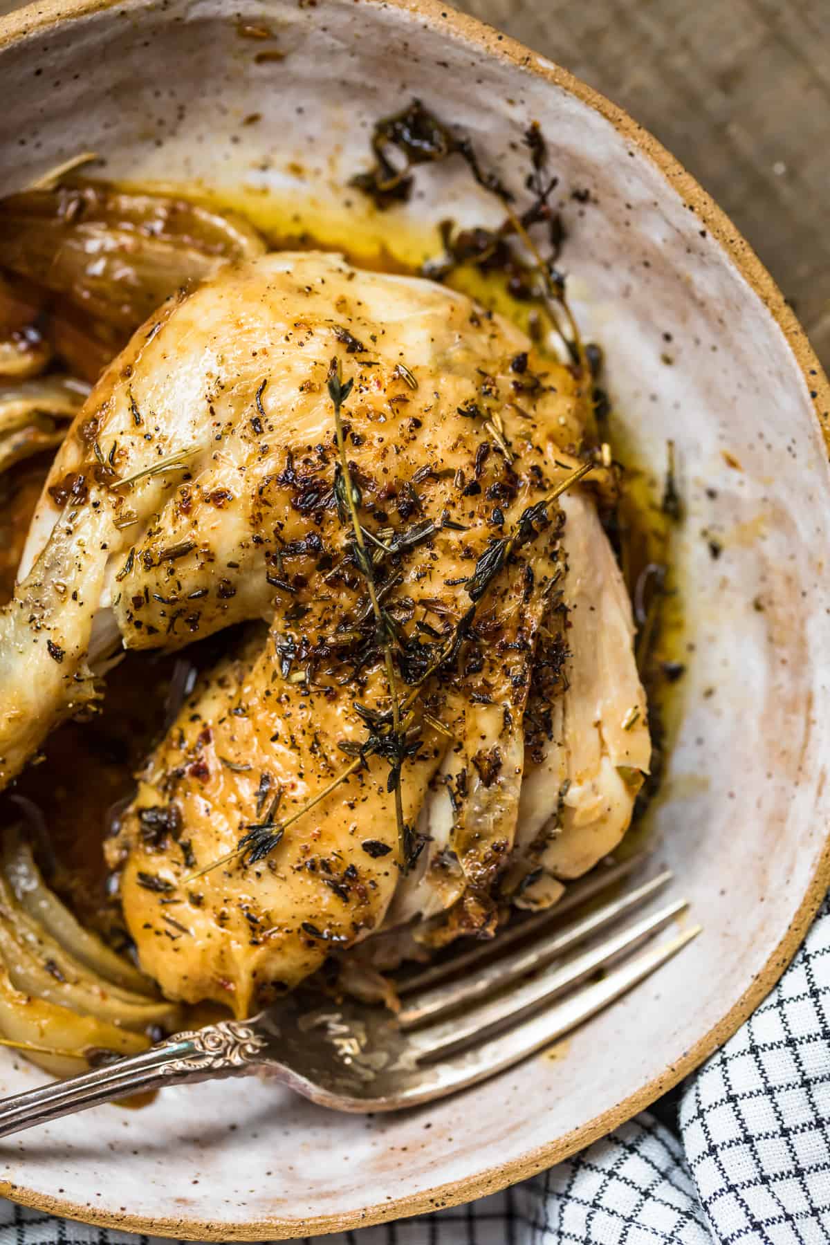 Close up of the herbs on the chicken thigh