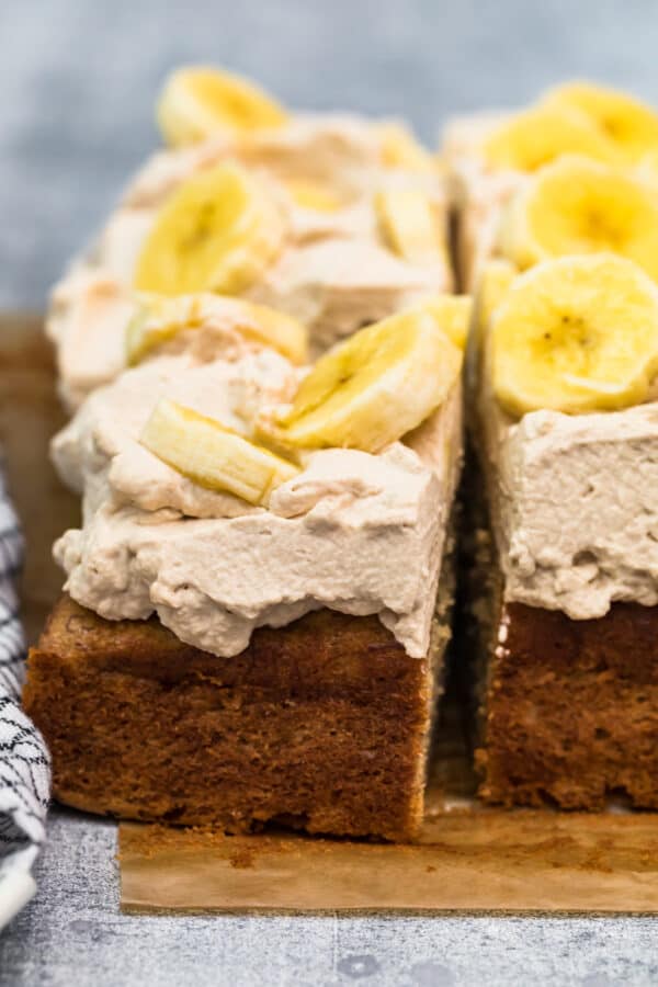 up close side shot of banana cake with whipped cream