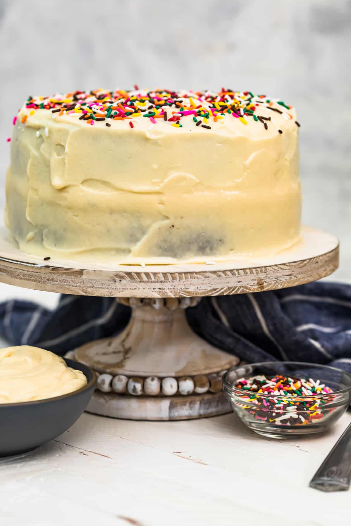 chocolate cake with white icing on cake stand