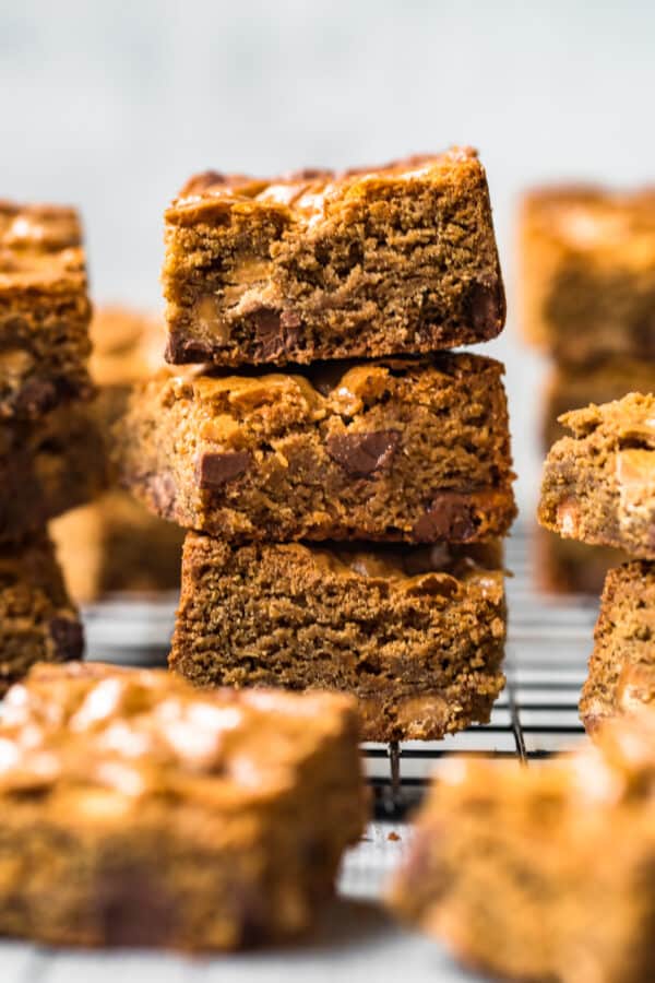 stacked chocolate peanut butter blondies on baking rack