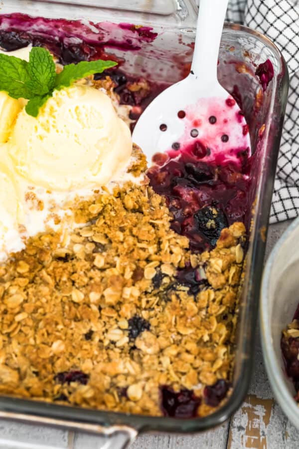 spoon in double berry crisp with ice cream