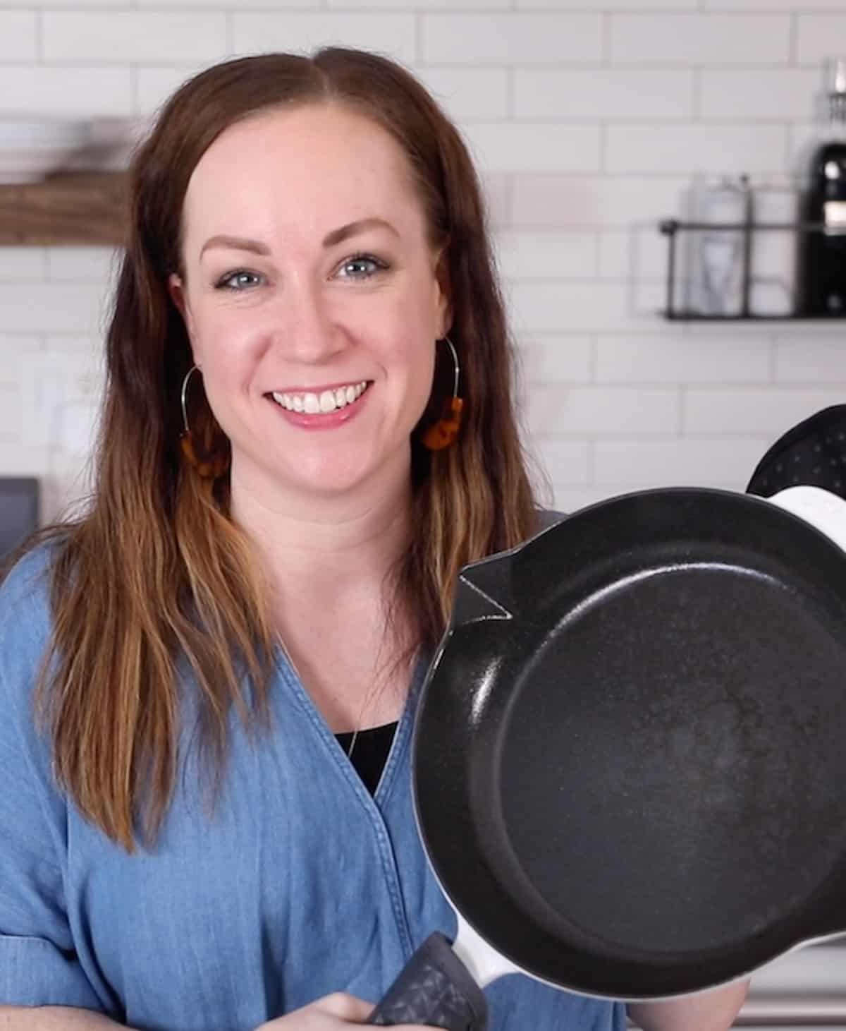 becky hardin holding up seasoned cast iron skillet