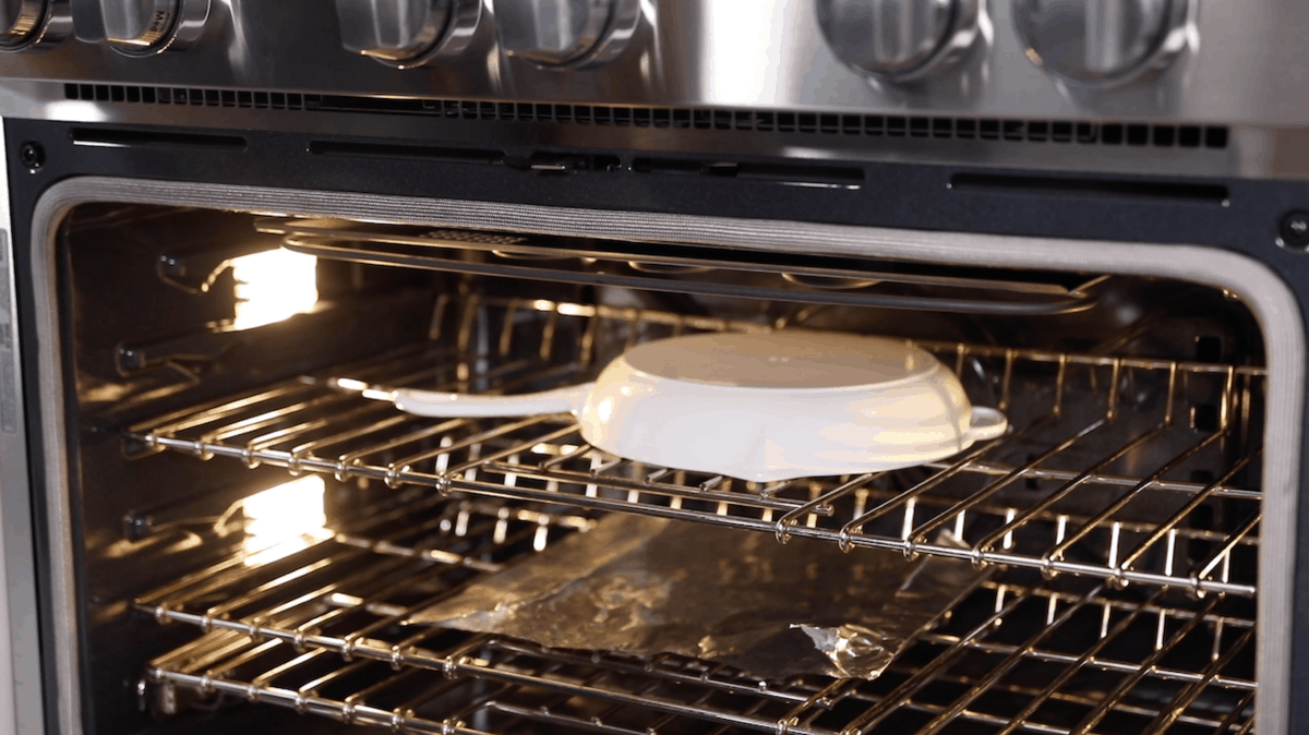 putting a skillet into the oven for seasoning