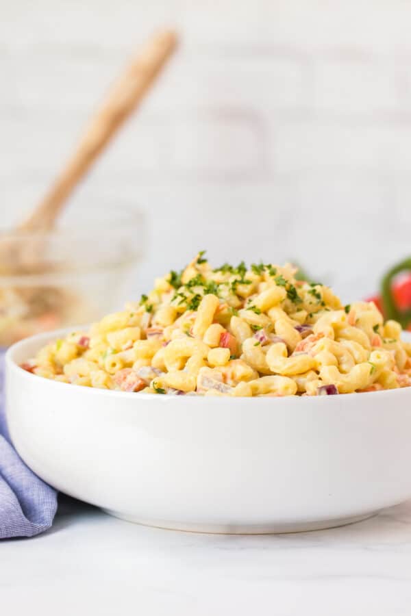 side image of macaroni salad in white bowl