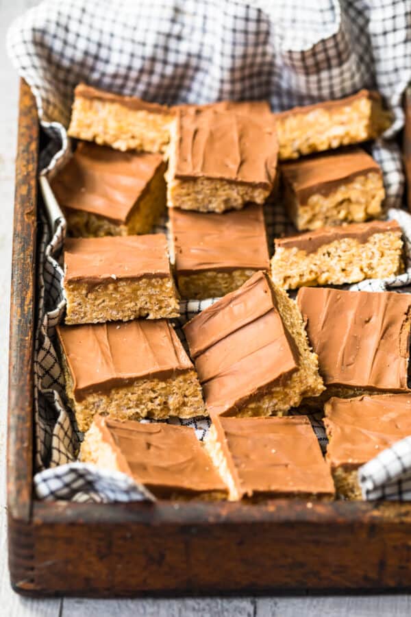 sliced scotcheroos in a box topped with chocolate