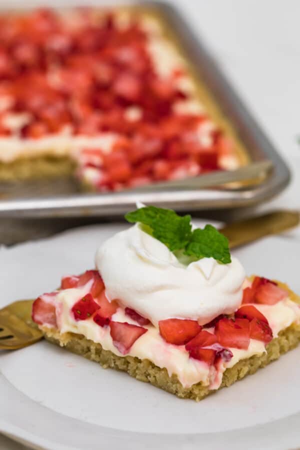 strawberry lemonade sugar cookie bar topped with whipped cream