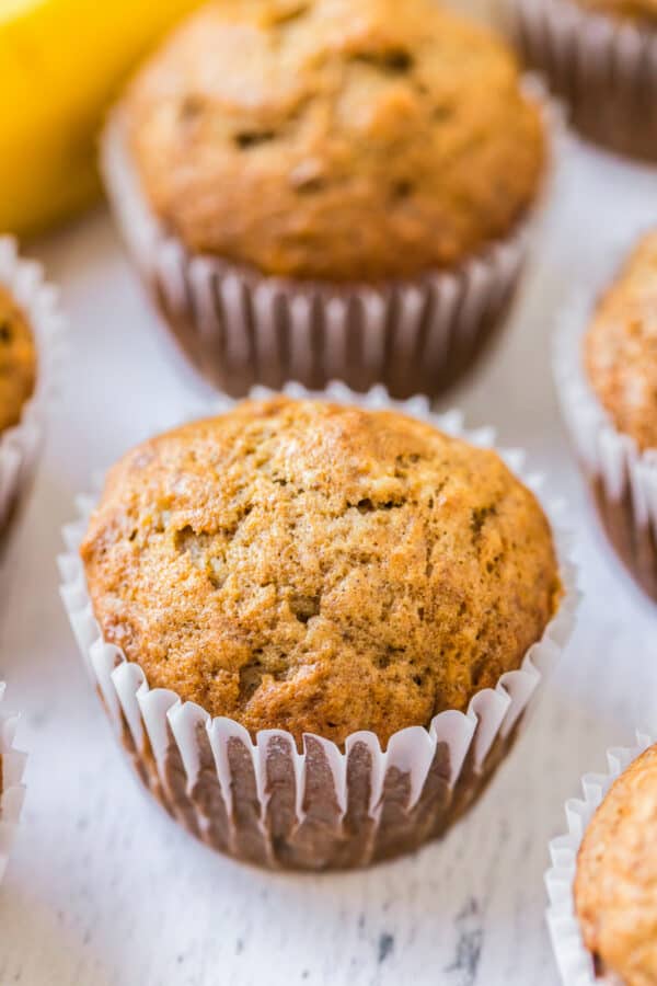 side shot of muffins on white wood