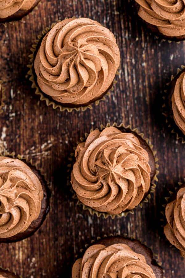 overhead image of chocolate buttercream icing on cupcakes