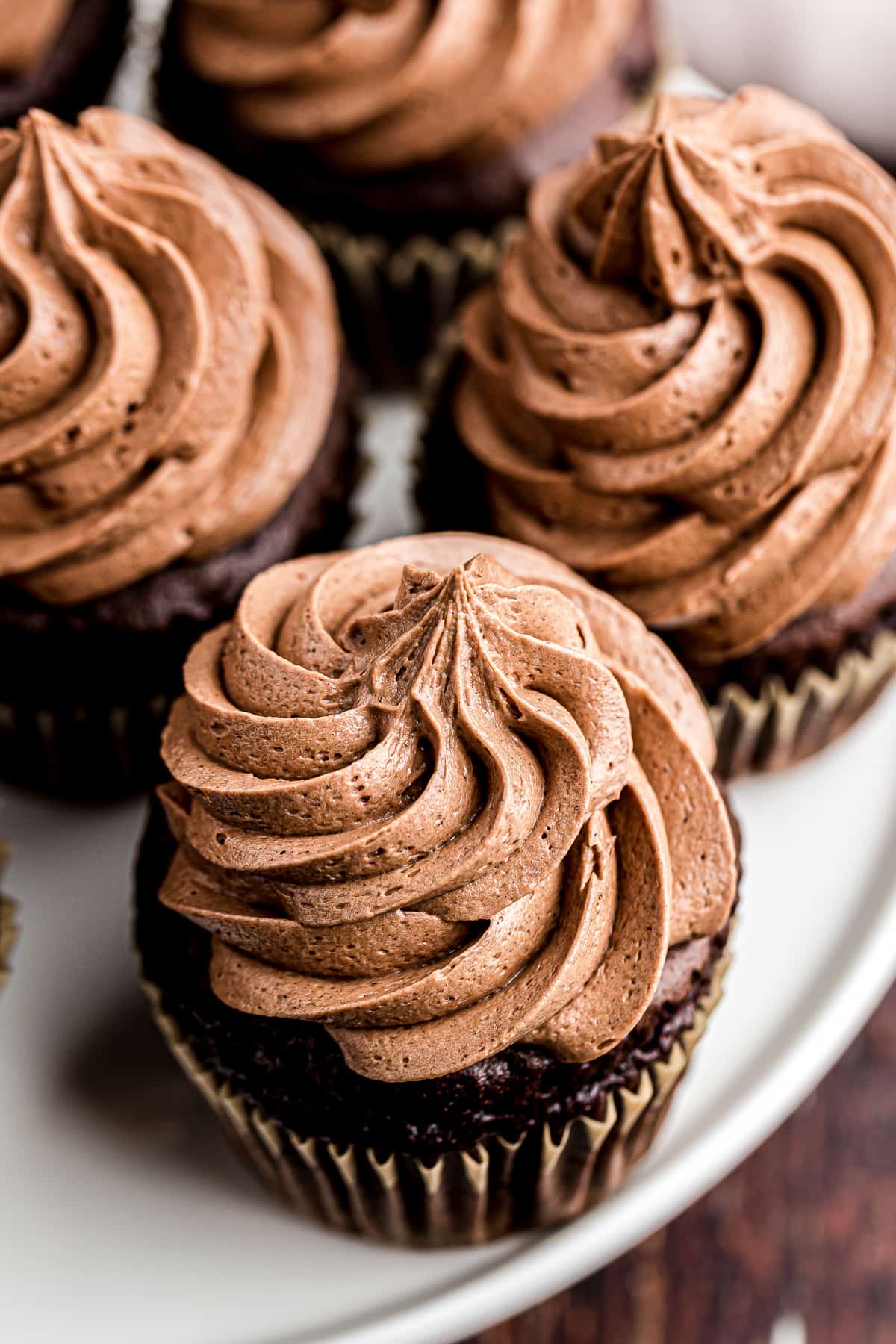 chocolate icing swirled onto cupcakes
