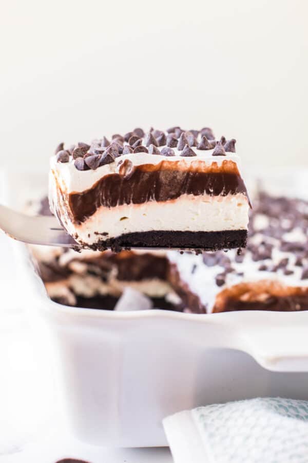 lifting up slice of chocolate lasagna from casserole dish