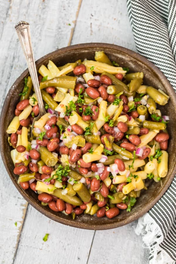 three bean salad in bowl with spoon