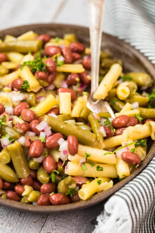 three bean salad in bowl with spoon