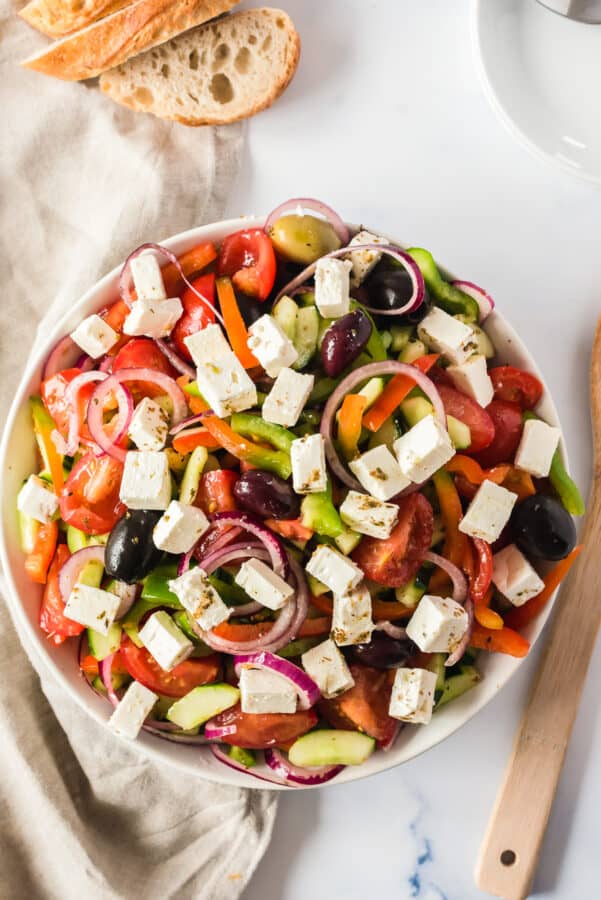 overhead image of traditional greek salad in white bowl
