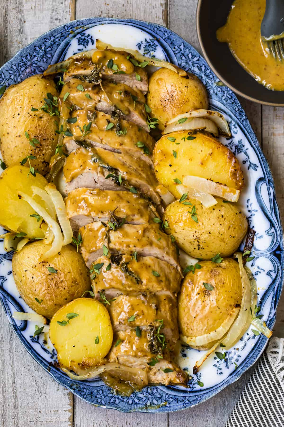 honey mustard pork tenderloin with potatoes on platter