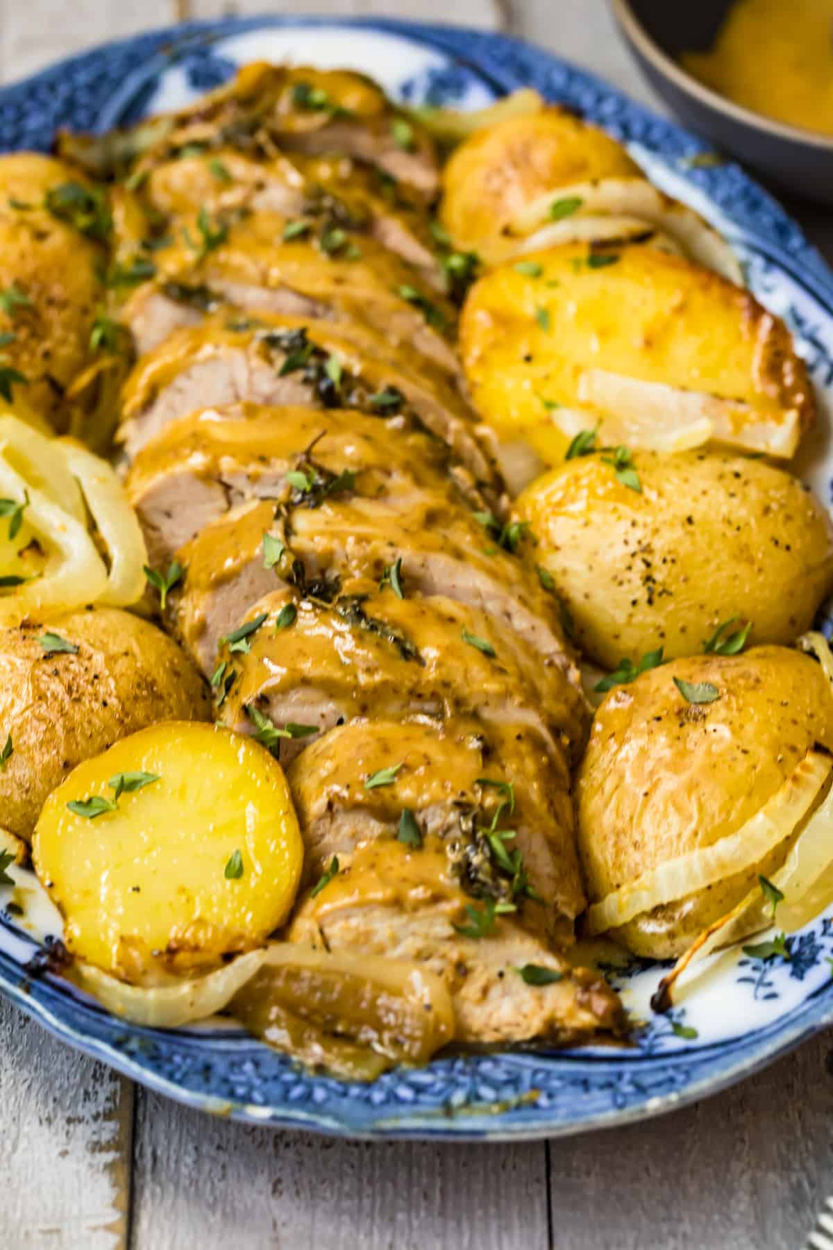 honey mustard pork tenderloin with potatoes on platter