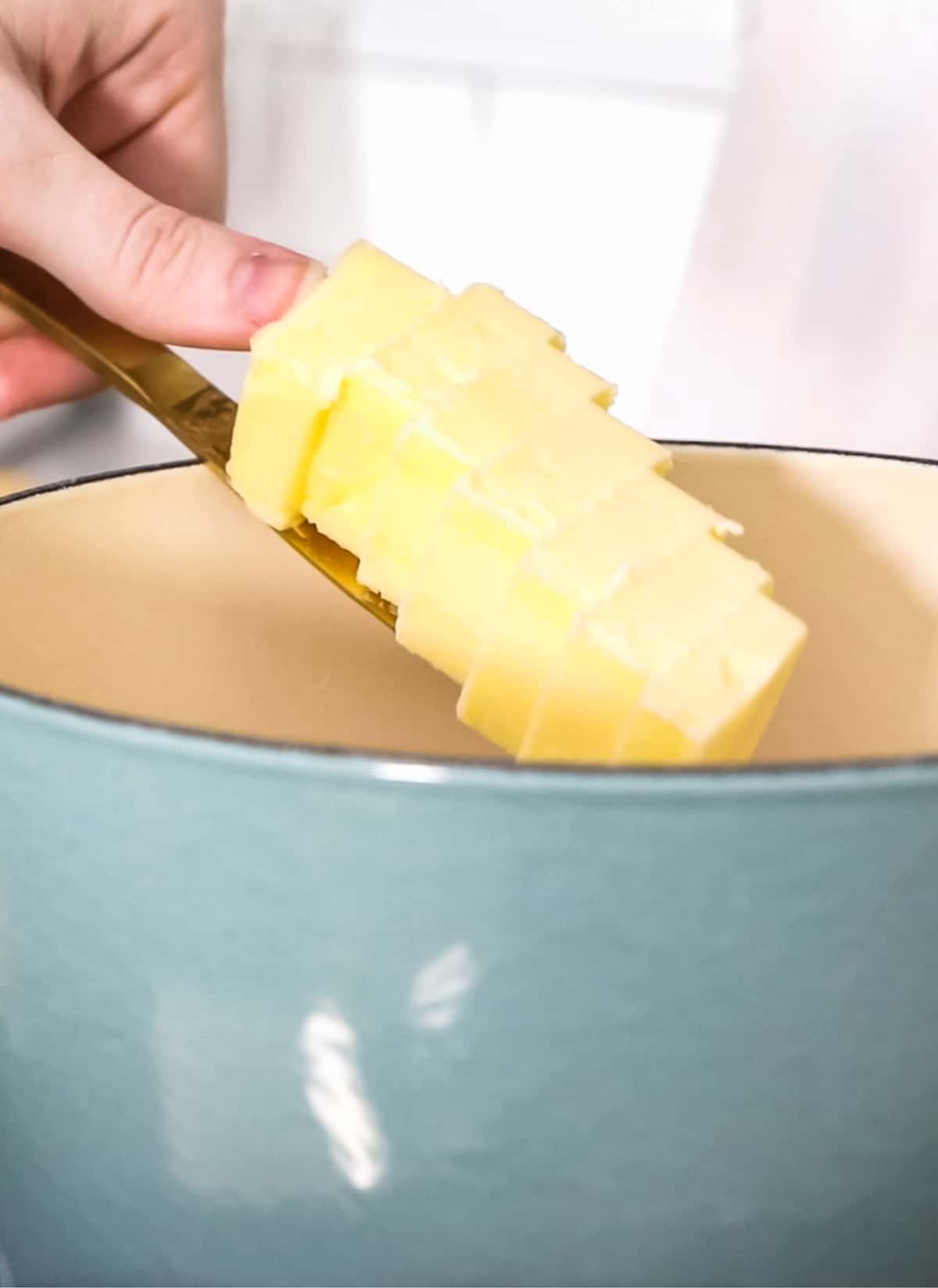 placing sliced butter in saucepan