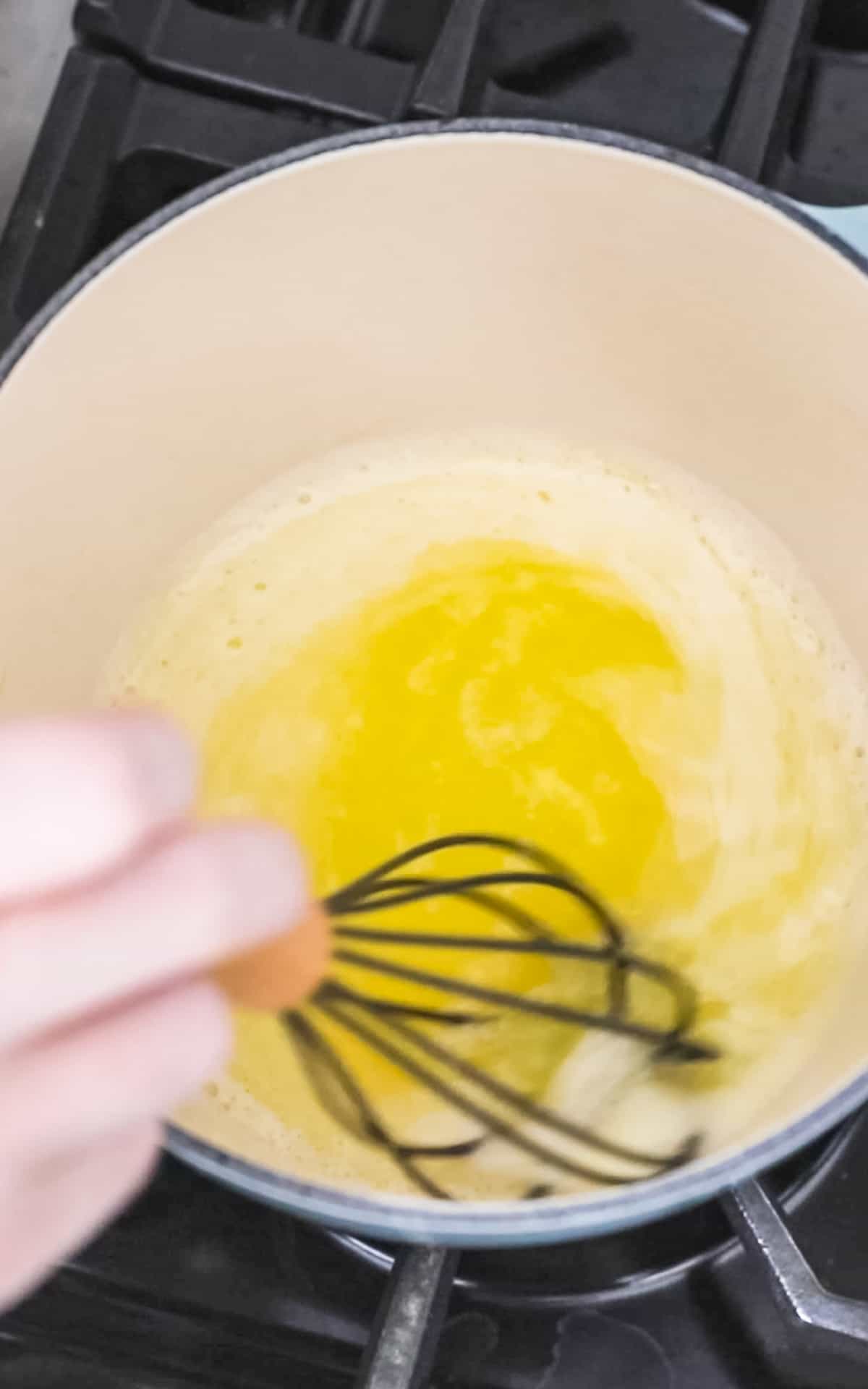 whisking melted butter in sauce pan