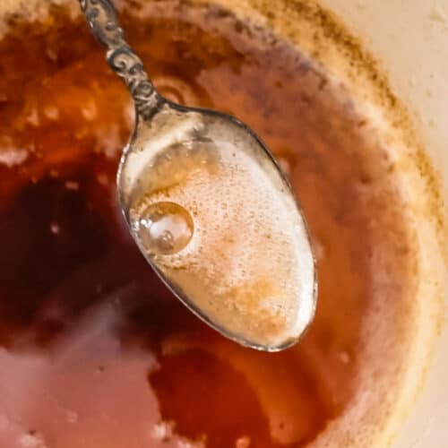 up close image of spoon lifting browned butter from pan