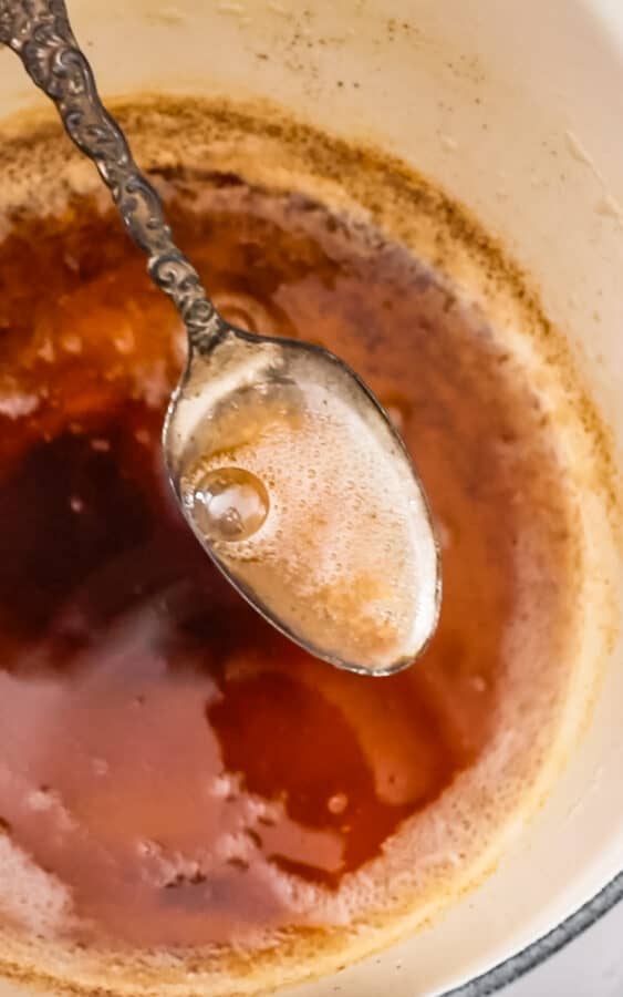 up close image of spoon lifting browned butter from pan